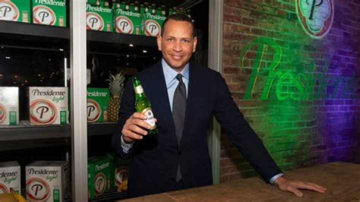 Who owns Presidente Beer?